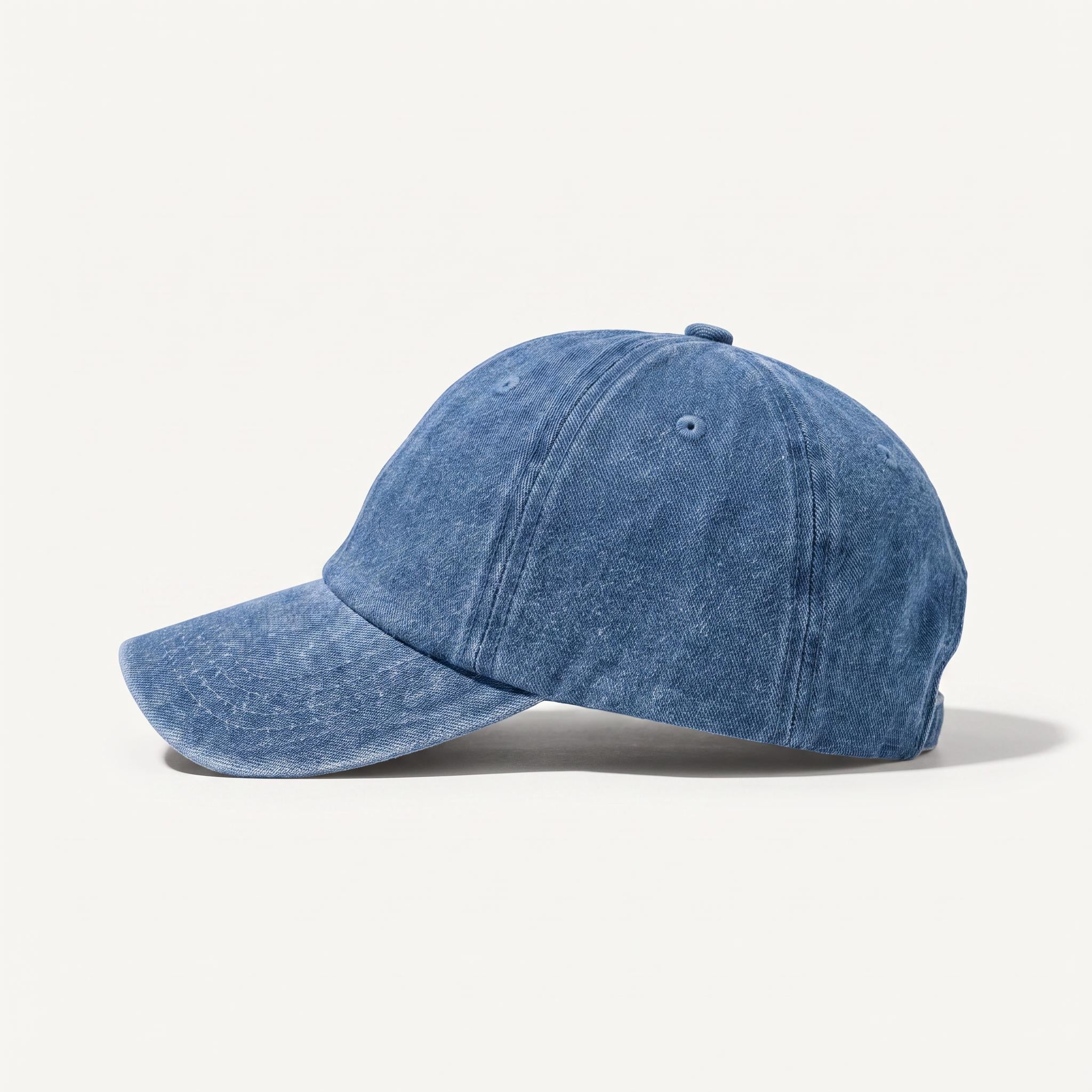 A washed blue denim baseball cap shown in profile against a clean, off-white background.