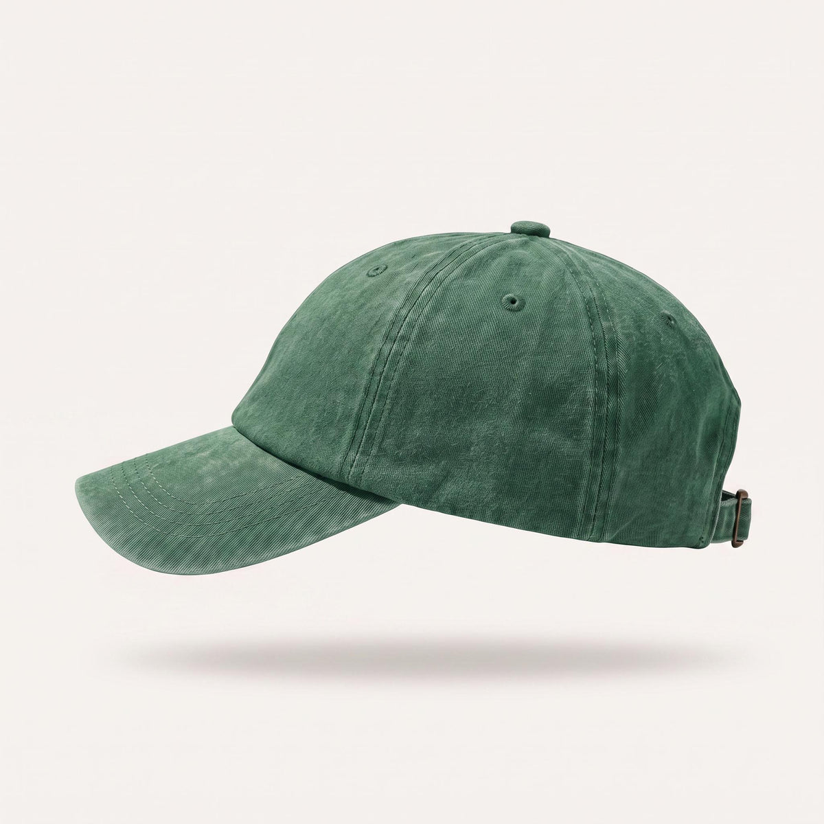 A washed dark gray baseball cap shown from a side profile against a light beige background.