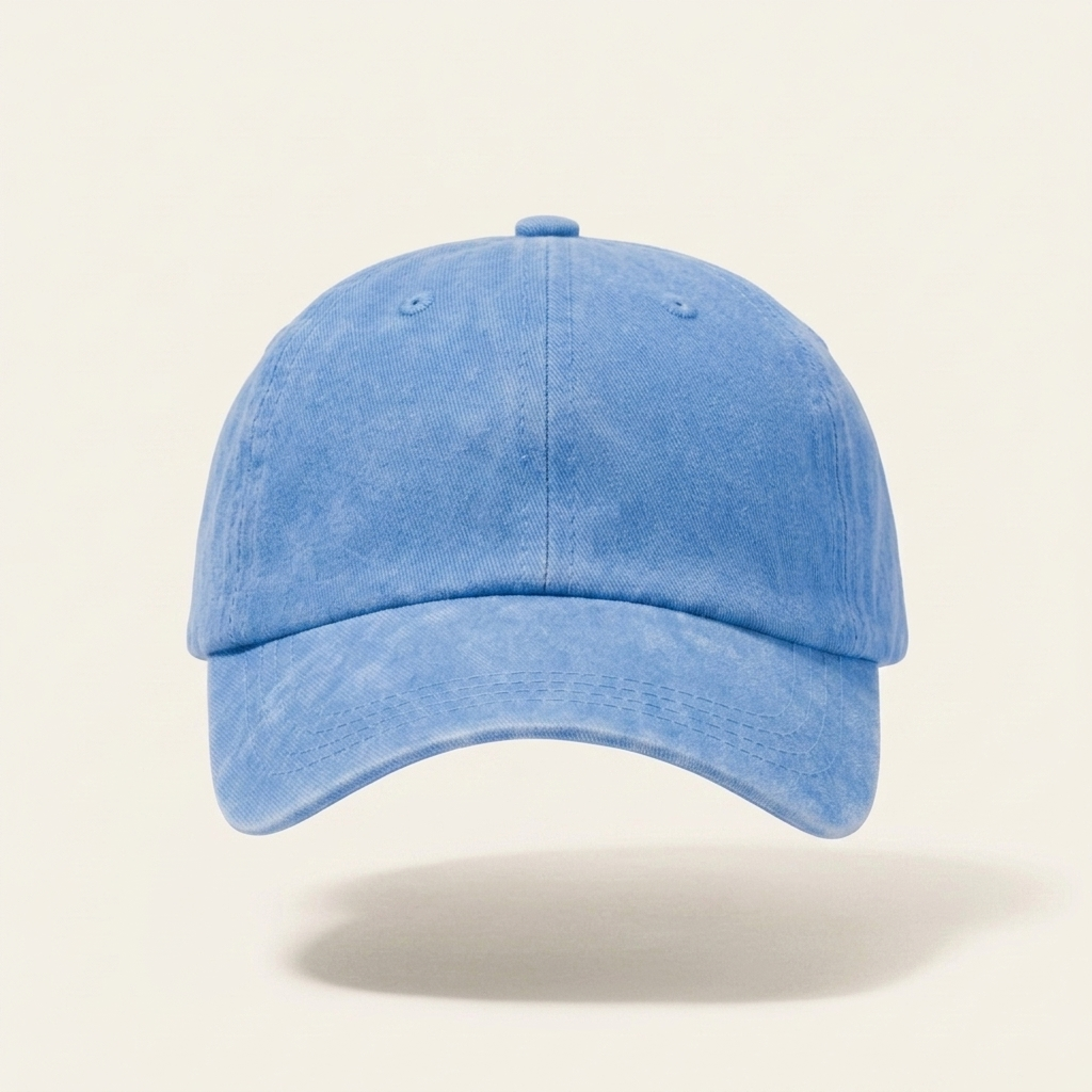 A light blue washed cotton baseball cap shown from the front on a clean, solid off-white background with a soft shadow underneath.