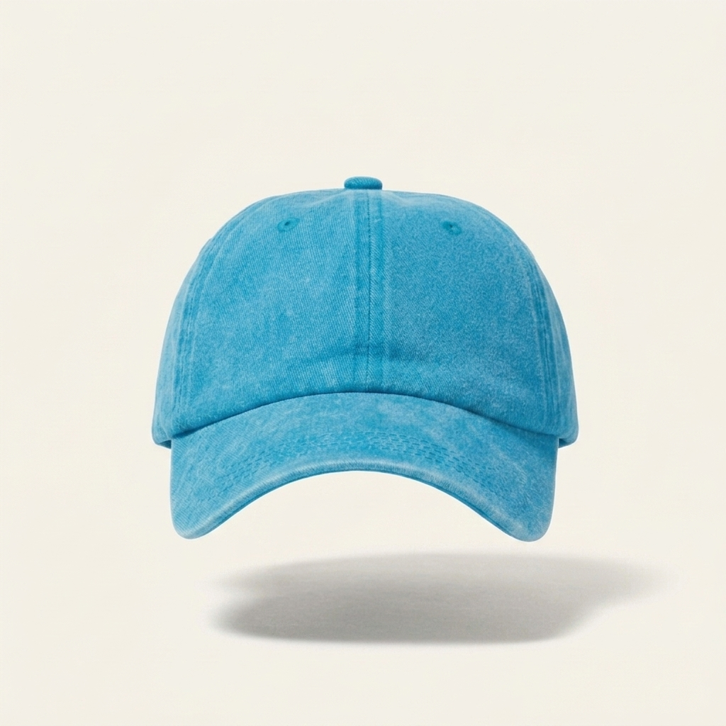 A light blue washed cotton baseball cap floating against a warm off-white background with a soft shadow underneath.