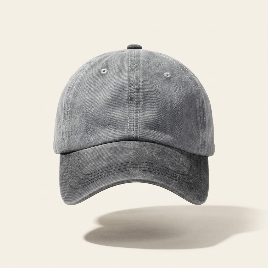 A washed dark gray baseball cap with a curved brim, shown floating against a light beige background with a soft shadow underneath.