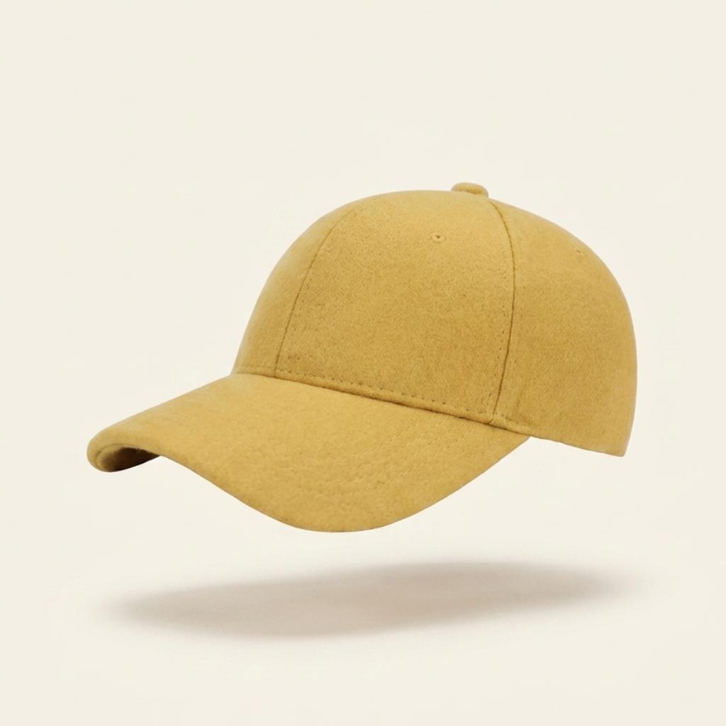 A classic six-panel baseball cap in a textured mustard yellow fabric, shown floating against a solid off-white background with a soft shadow underneath.