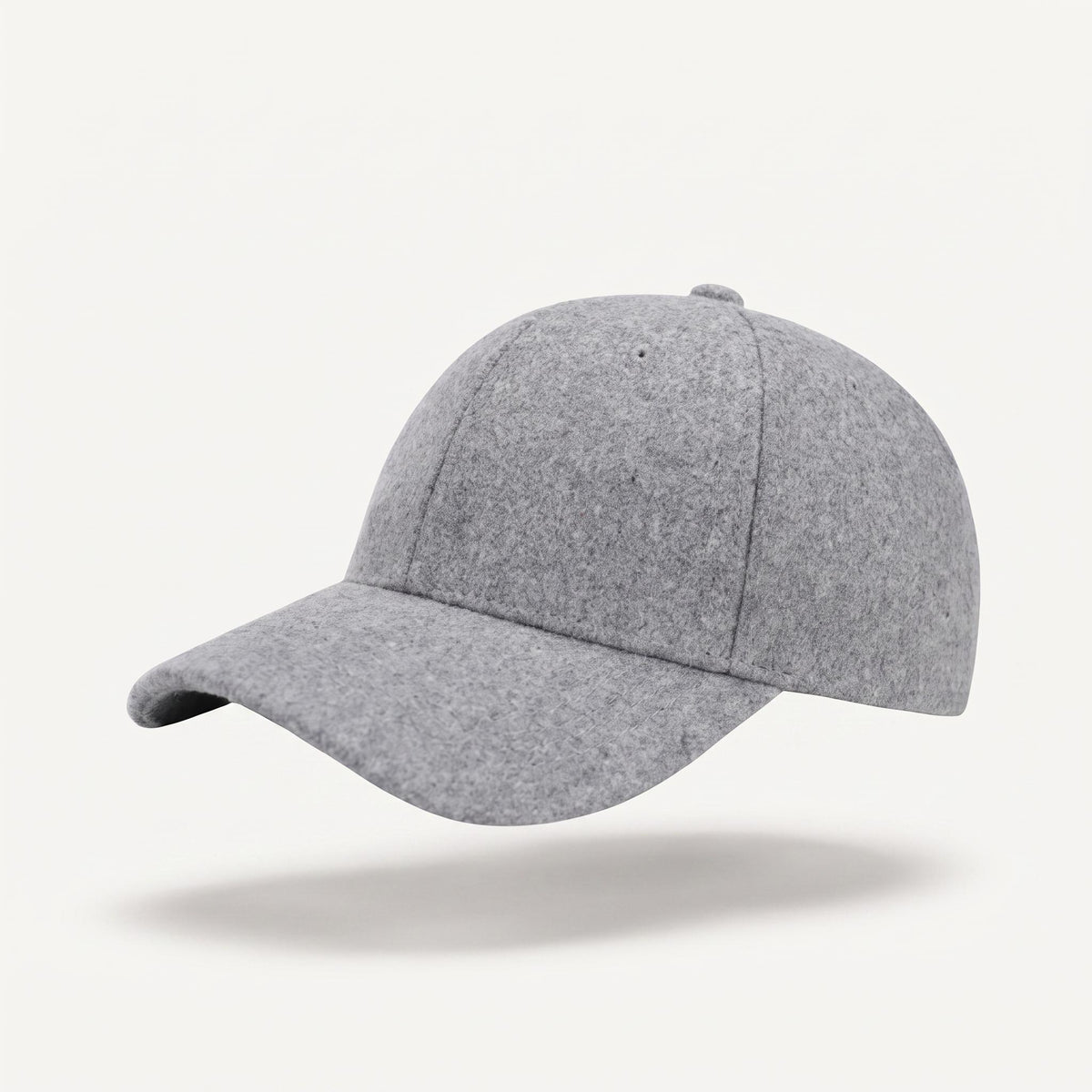 A light gray felt baseball cap floating against a clean off-white background with a soft shadow underneath.