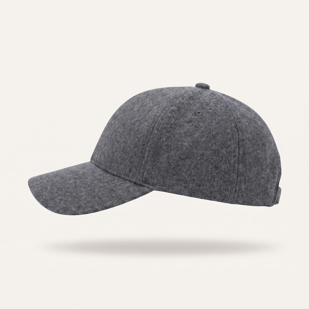 A classic six-panel baseball cap in a muted teal color, shown from a side profile view against a clean white background.