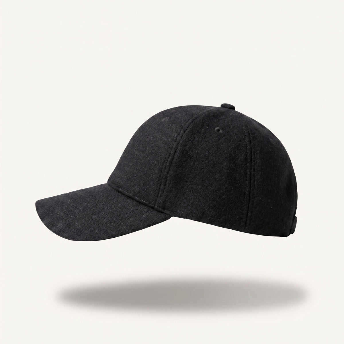 A dark charcoal gray baseball cap with a curved brim, shown floating against a light off-white background with a soft drop shadow underneath.
