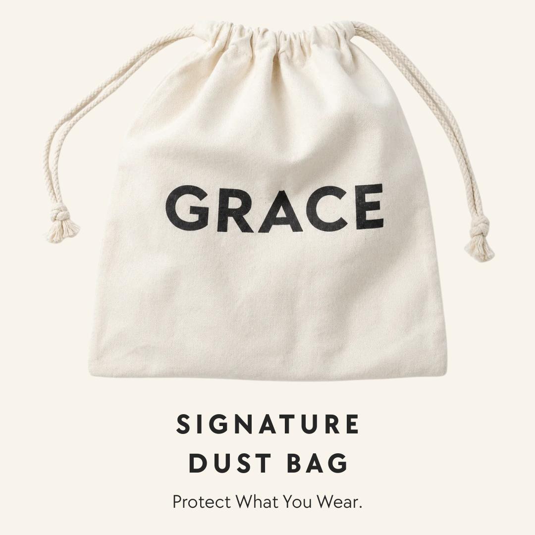 An off-white canvas drawstring dust bag with the word 'GRACE' printed in bold black letters, shown against a light cream background with the text 'SIGNATURE DUST BAG' and 'Protect What You Wear.' below.