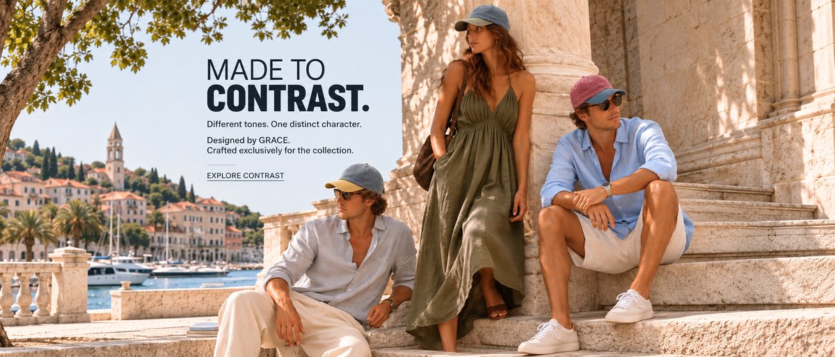 Three models sitting on stone steps outdoors in front of a coastal cityscape, wearing light blue, olive green, and beige outfits. Large text on the left reads 'MADE TO CONTRAST.