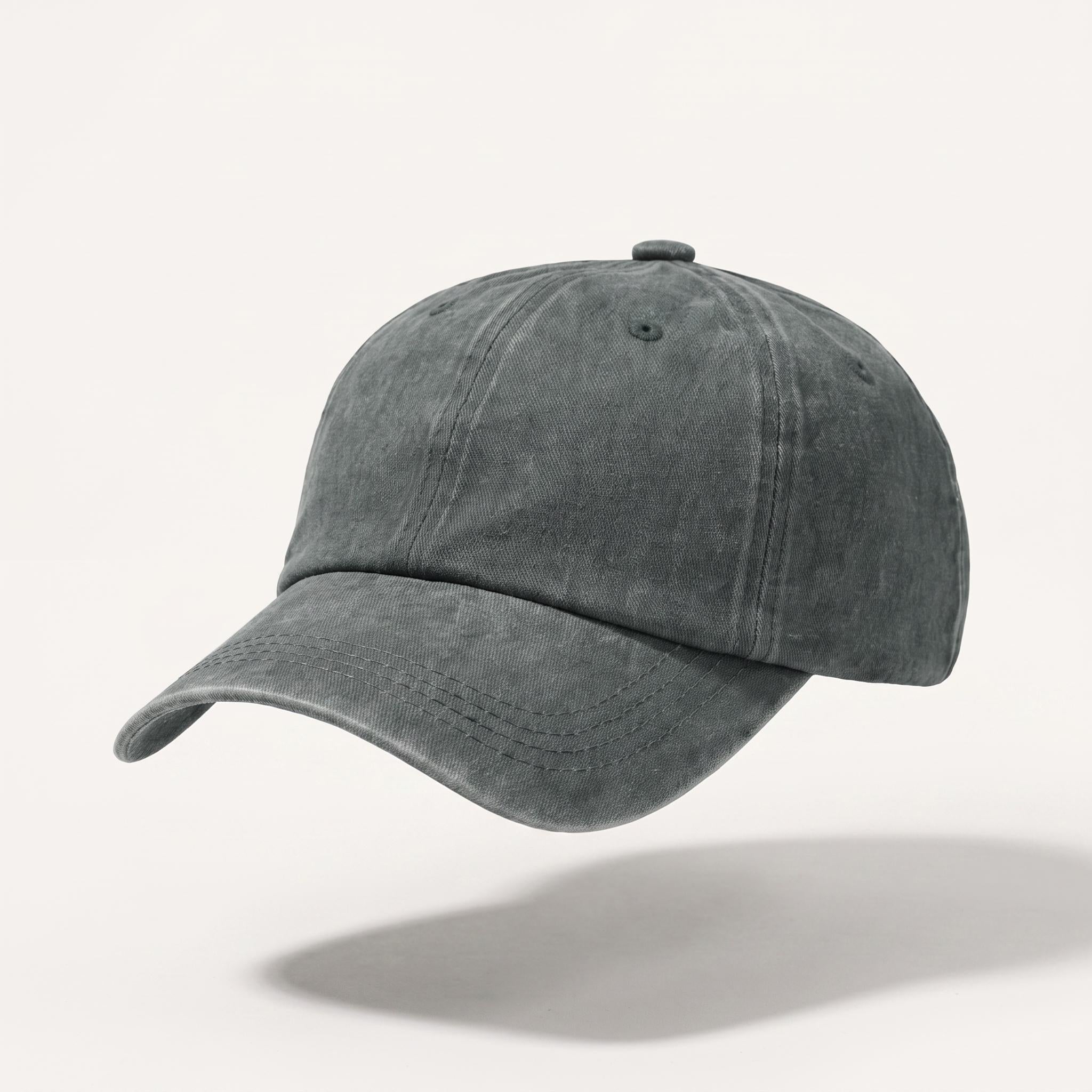 A washed dark gray baseball cap with a curved brim, shown floating against a light off-white background with a soft shadow underneath.