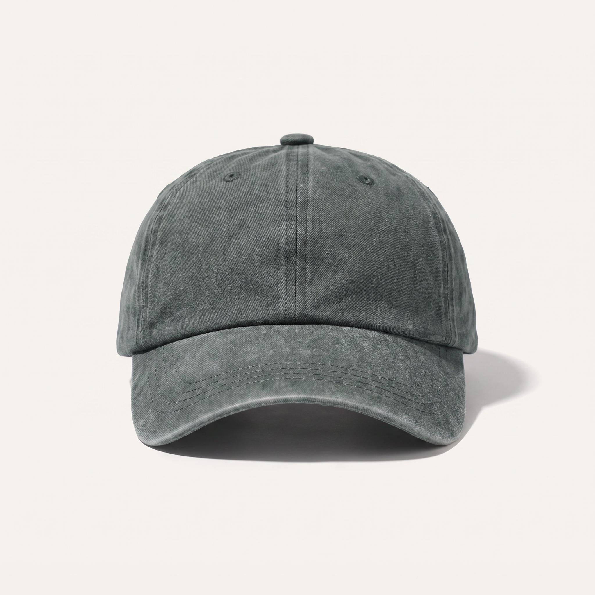A washed dark gray baseball cap with a curved brim, shown from the front on a light beige background.