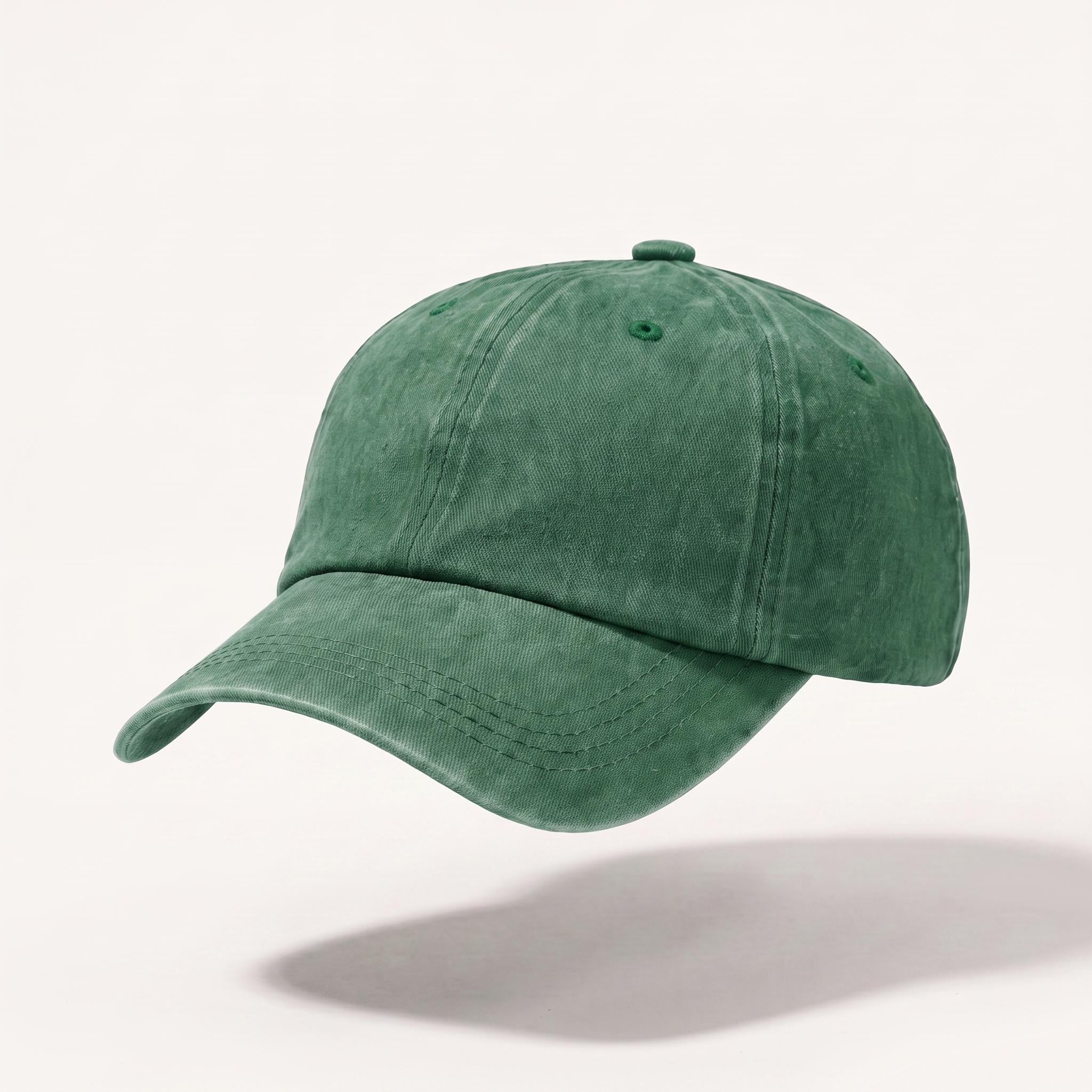 A green washed cotton baseball cap floating against a light off-white background with a soft shadow underneath.