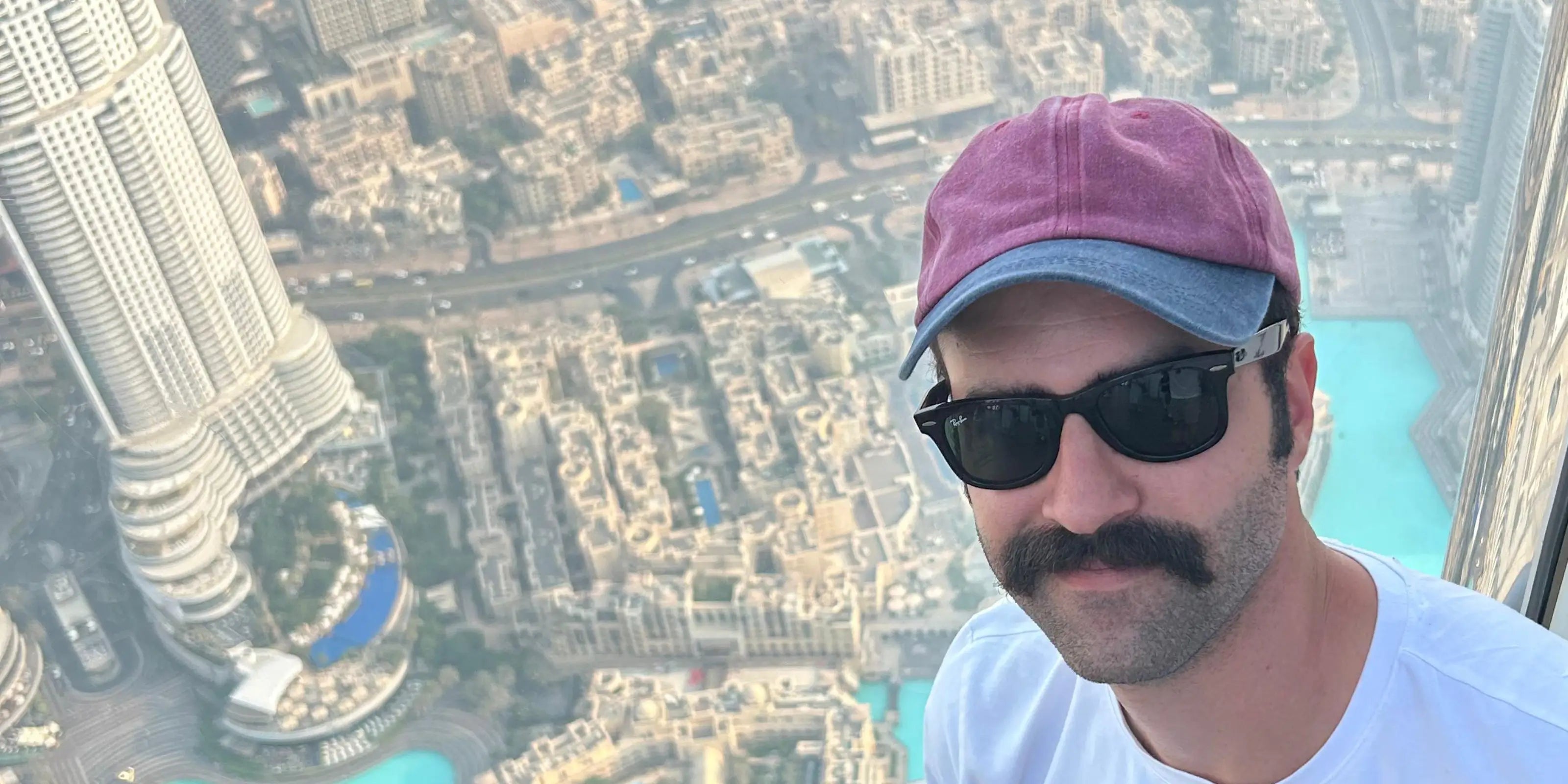 Person taking a selfie with a cityscape view from a high vantage point