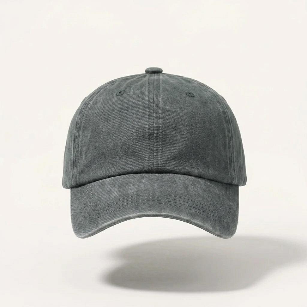 A washed dark gray baseball cap with a curved brim, shown floating against a light off-white background with a soft shadow underneath.