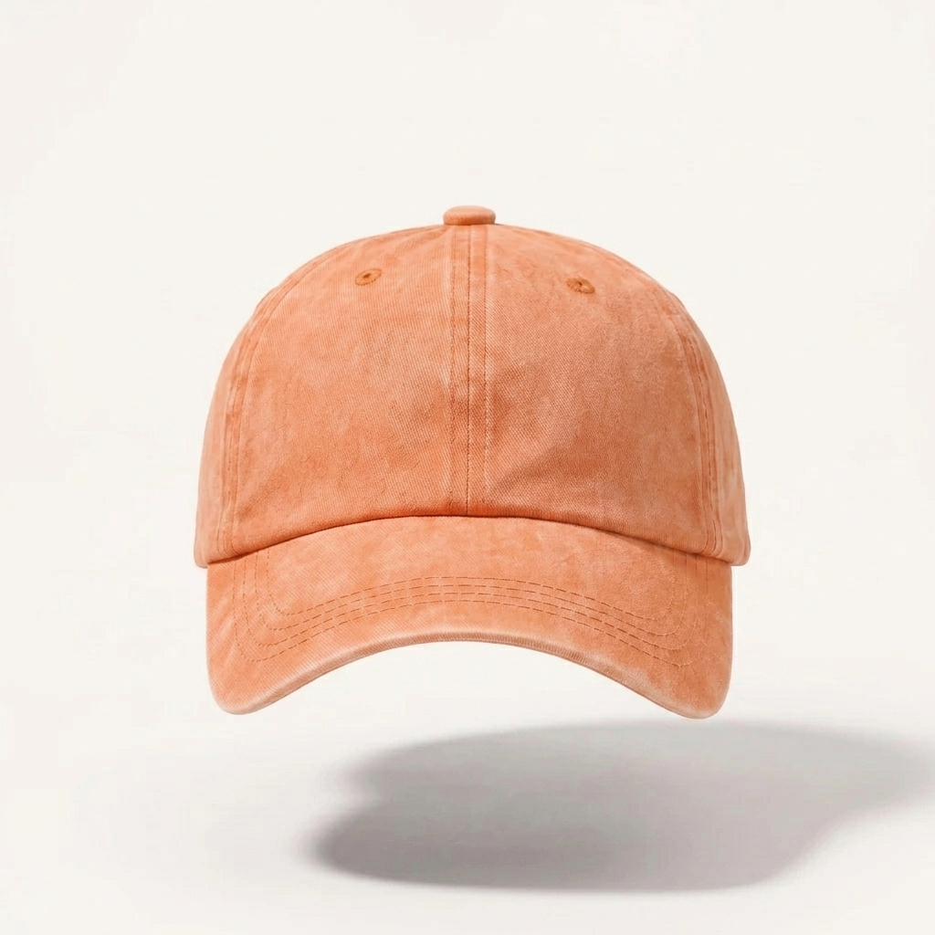 A washed peach-colored cotton baseball cap shown from the front against a clean white background.
