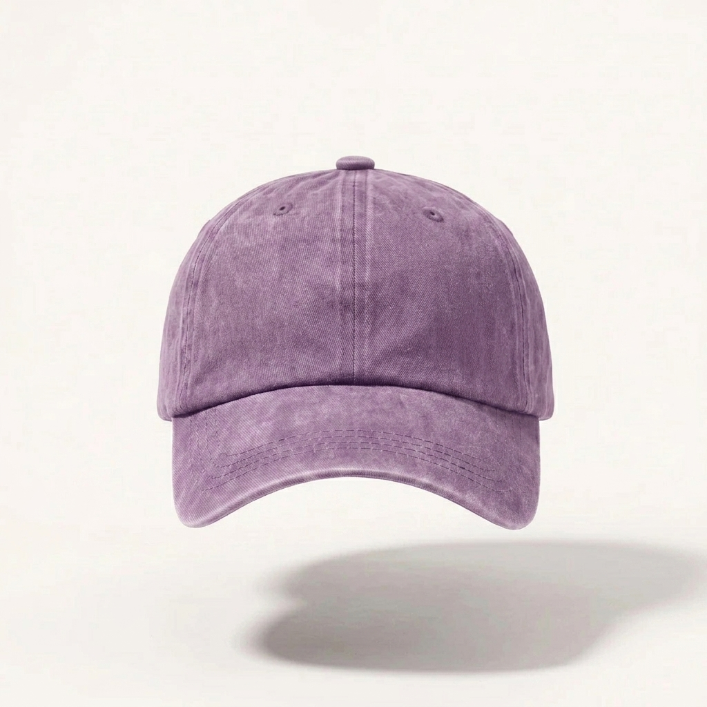 A washed purple cotton baseball cap shown from the front against a light off-white background with a soft shadow below.