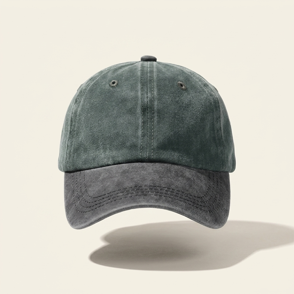 A washed dark green and charcoal gray baseball cap with a curved brim, shown floating against a light beige background with a soft shadow underneath.