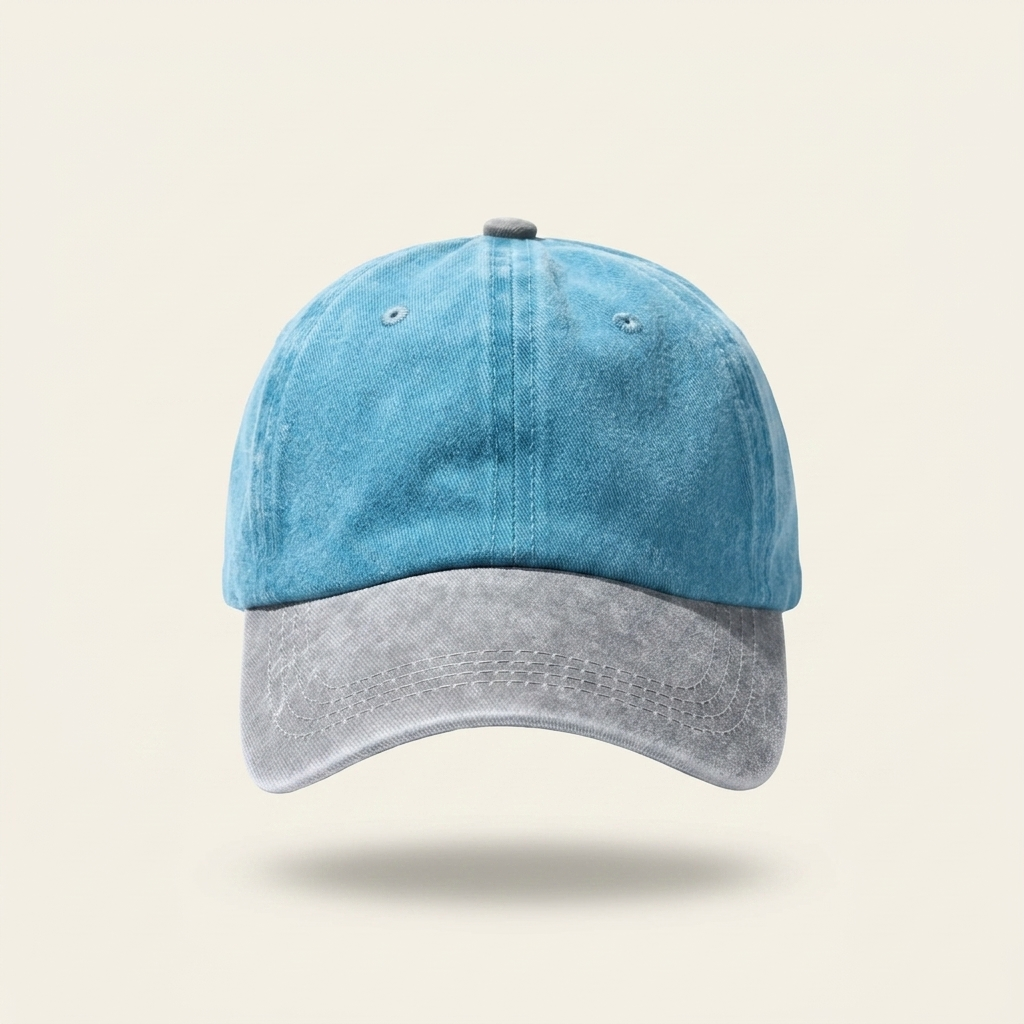 A two-tone baseball cap with a washed light blue crown and a distressed gray brim, shown against a solid light beige background.