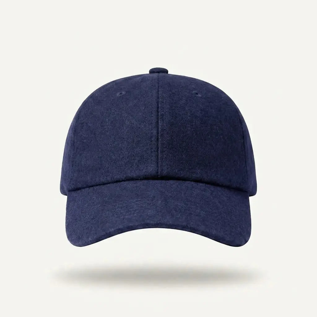 A navy blue baseball cap with a curved brim, shown from the front against a light off-white background with a soft shadow underneath.