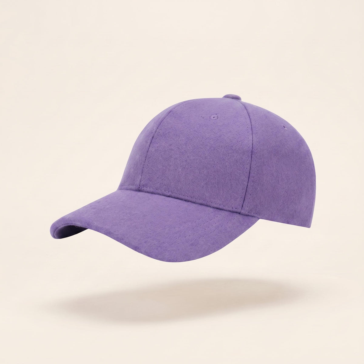 A solid purple baseball cap floating against a light beige background with a soft shadow underneath.