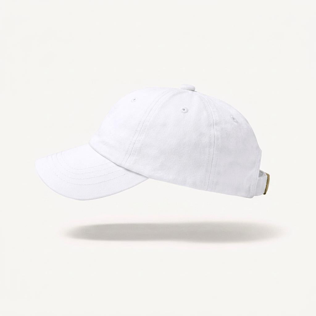 A plain white baseball cap floating against a light cream background with a soft shadow underneath.