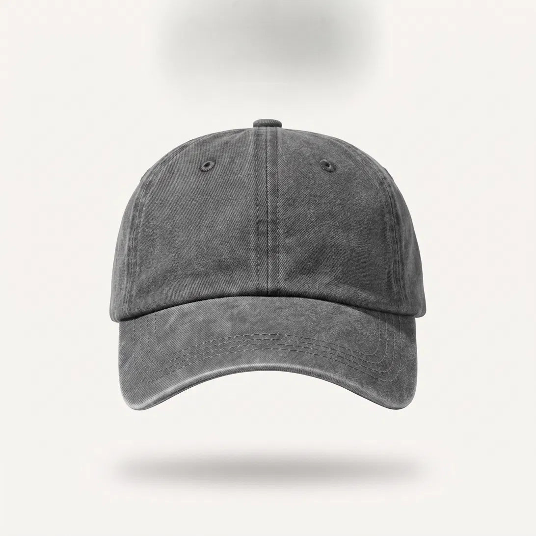 A dark gray washed cotton baseball cap shown from the front on a clean, light off-white background with a soft drop shadow.